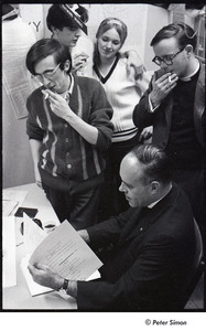 Malcolm Boyd at Boston University: Boyd (seated) in the BU News room with (l-r) Raymond Mungo, Joe Pilati, an unidentified woman, and an unidentified man