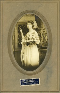 Polish American woman with bouquet of flowers: three quarter-length studio portrait in oval folder