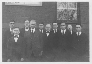 Kenyon L. Butterfield posing with Dean Machmer and other faculty members