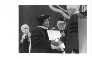 Coretta Scott King receives a doctor of humane letters honorary degree from Suffolk University President David J. Sargent (1989-2010) at the 1997 commencement at the Fleet Center
