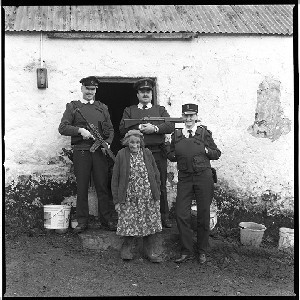 RUC officers from Clogher station with Sarah Primrose who lived on a farm off the beaten path. These officers kept an eye on her welfare especially in the Winter, as she had no electricity or piped water. Sarah has since died
