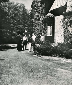 Saint Joseph's Hall exterior: side with priest and students talking