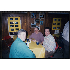 Three Bunker Hillbilly alumni sit at a table during a reunion event