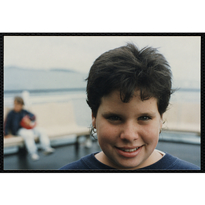 A girl poses for a candid photo abroad a ship