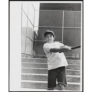 A boy swings a baseball bat