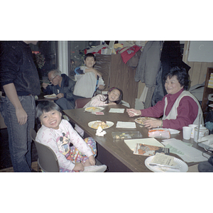 Guests eating during a Chinese Progressive Association anniversary event