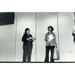 Three people perform a theatrical sketch onstage at the Josiah Quincy School about the normalization of U.S. and China relations