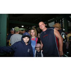 A man, a woman, and two children inside Fenway Park
