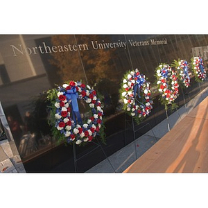 Five wreaths hang on the Veterans Memorial during the dedication ceremony
