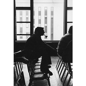 Silhouette of a student smoking a pipe