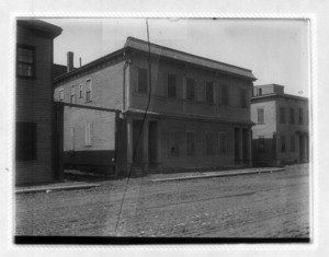 View of dirt road in front of buildings, probably Dorchester Ave.