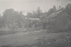 Farm buildings with two women in background