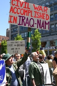 Marchers carrying signs reading 'Civil war accomplished in Iraq-Nam' and 'You can't be fair and balanced and be Fox,' during the protest against the war in Iraq