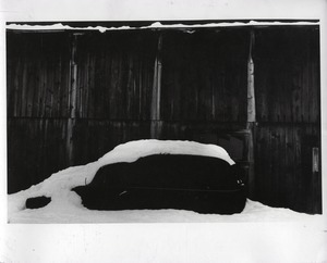 Car and barn under heavy snow, Montague Farm Commune