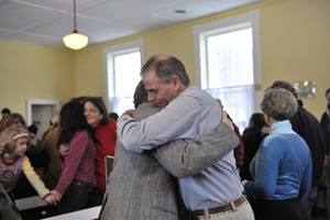 Aftermath of the Congregational Church fire in West Cummington, Mass.: emoitonal parishioners hugging one another