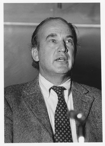 David A. Booth in front of microphone