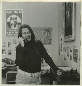 Joan P. Bean standing indoors, talking on the phone