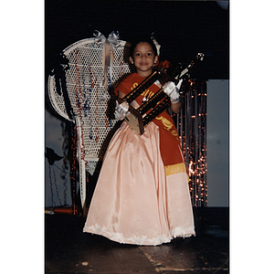 A little girl carries a large trophy during the Festival Puertorriqueño