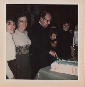 Fr. John Silva cutting cake