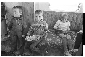 Traveller families in a layby outside of Downpatrick, Co. Down. Children eating in a caravan