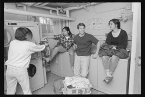 Photographs of students in a laundry room, 1993 April
