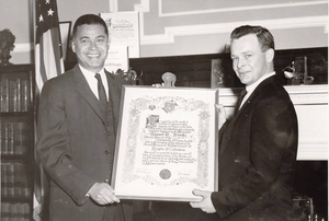 Attorney General Edward Brooke is presented scroll by Johnny Holland, Grand Knight of the Knights of Columbus