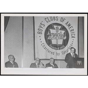 William J. Lynch, at far right, speaking from the podium at a Boys' Clubs of America event