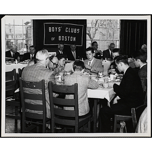 Officers and guests eat and converse at a Boys' Clubs of Boston awards event