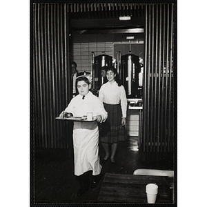A member of the Tom Pappas Chefs' Club carries a tray in a Brandeis University dining hall
