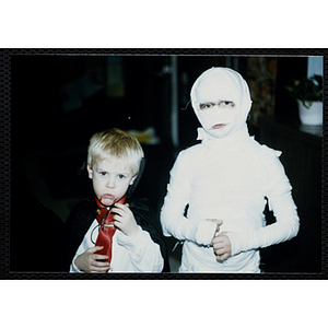Two children pose in their Halloween costumes