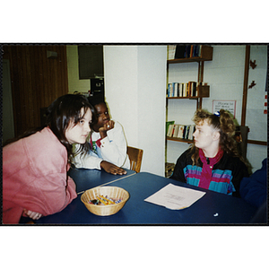 Three girls sit at a table at a Tri-Club event