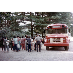 Chinese Progressive Association members gather near a bus on their trip to Benson's Animal Farm