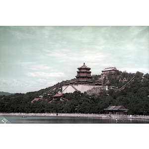 Chinese building on a hillside overlooking a body of water