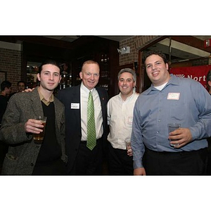 Jack Moynihan poses with three men at the Northeastern University New