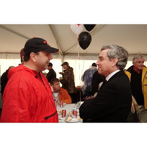 President Freeland speaks to a supporter before the Homecoming game