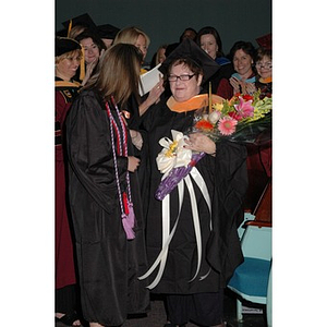 Students present faculty member with flowers at School of Nursing convocation