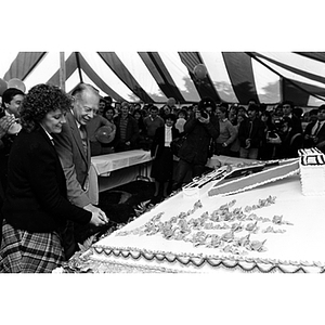 President Ryder and Harriet Wall cut into a giant cake at the 75th anniversary celebration of the Cooperative Education program