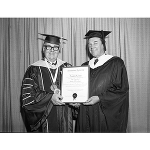 Franklin Norvish stands with President Knowles and his Distinguished Service Certificate