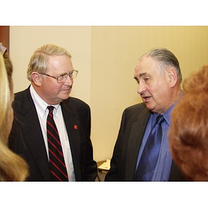 Neal Finnegan (CBA '61), left, and Harry P. Keegan III (CBA '64) conversing with others at the College of Business Administration's Distinguished Service Awards ceremony