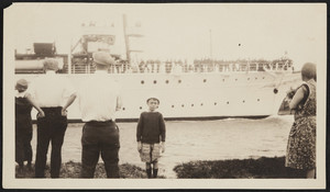 A boy poses in front of the Presidential Yacht