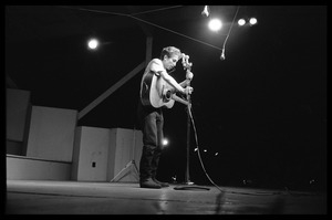 Bob Dylan performing on stage, Newport Folk Festival