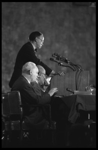 Arthur M. Schlesinger, Jr., speaking at the National Teach-in on the Vietnam War, with other seated panelists Hans J. Morgenthau (left) and Isaac Deutscher