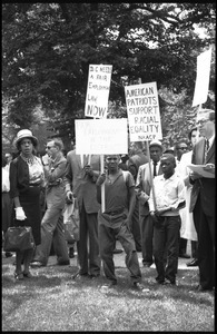Young protesters holding signs demanding racial equality and fair employment in Washington, D.C.