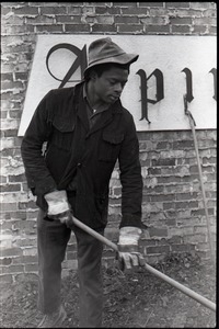 Young African American man working with a pitchfork