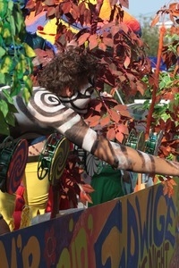 Parade marcher in full black and white body paint reaching out to the crowd : Provincetown Carnival parade