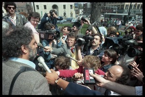 Scene outside the Hampshire County courthouse following acquittal in the CIA protest trial: Abbie Hoffman being interviewed by the press