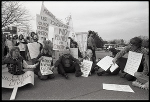 Protests against U.S. intervention in Nicaragua at Westover Air Force base: protesters seated on the pavement, including Frances Crowe (third from right)
