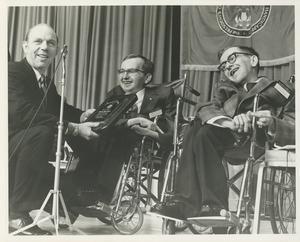 A man presents the 1970 President's Trophy to Richard and Robert Santin