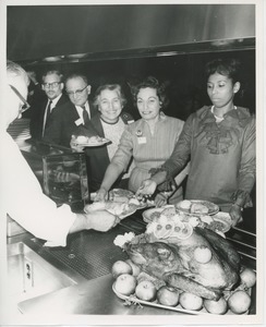 Staff getting plates of food at Thanksgiving celebration