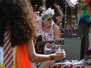 Parade watcher with electric guitar and amp : Provincetown Carnival parade
